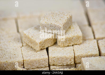 Sugar cubes on table background / Close up of brown sugar stacked in box , selective focus Stock Photo