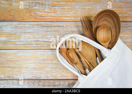 Natural kitchen tools wood products / Kitchen utensils background with spoon fork chopsticks plate cutting board object and cloth bag , top view on th Stock Photo