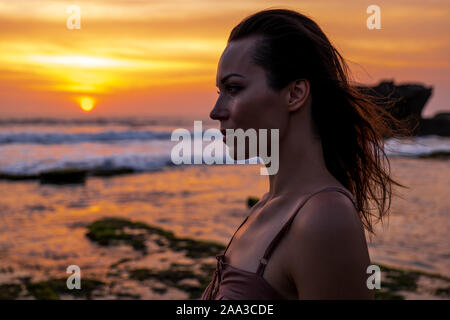 Woman against Pura Tanah Lot temple , Bali Stock Photo