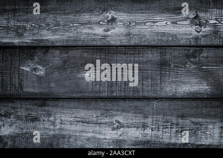 Shabby dark wood texture. Vintage wooden black fence, desk surface. Natural gray color. Weathered timber background. Dirty old wood planks. Stock Photo