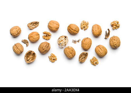 top view walnuts closed and broken scattered on a white background Stock Photo