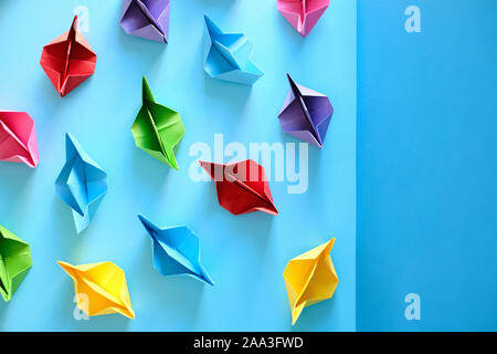 Fleet Of Authentic Origami Boats On Blue Background Stock Photo