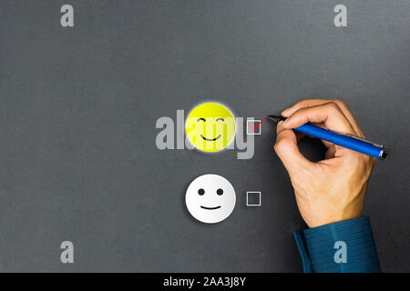 Conceptual the customer responded to the survey. The client using pen checkbox on happy face smile icon. Depicts that customer is very satisfied. Serv Stock Photo