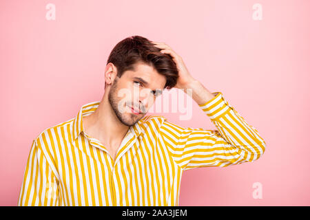 Photo of handsome guy holding hand in perfect hairdo style beauty treatment concept serene looking on camera wear hipster striped shirt isolated pink Stock Photo