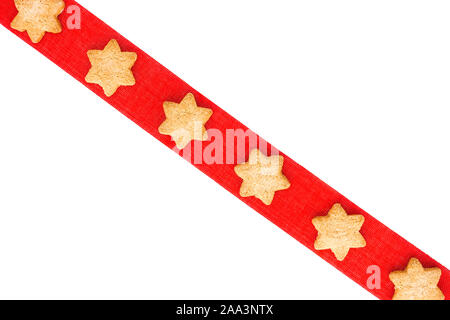 Top view of Christmas cookies on red ribbon as Christmas background. Stock Photo