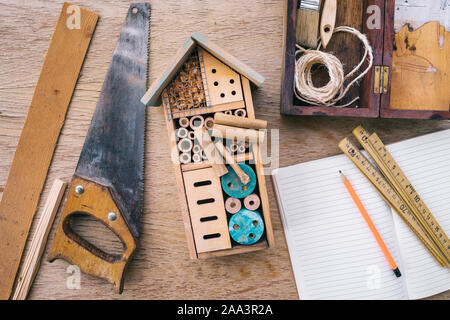 Making wooden insect house decorative bug hotel, Stock Photo