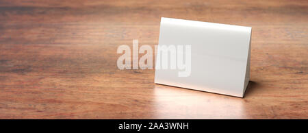Reservation concept. Table tent blank, reserved card sign template against wood background. White paper cardboard, copy space, banner. 3d illustration Stock Photo