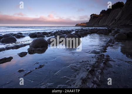 Rock formations in the Pacific Ocean at Bowling Ball Beach, California, USA Stock Photo