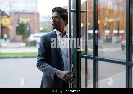 Young handsome Indian man in an office suit and white shirt Stock Photo