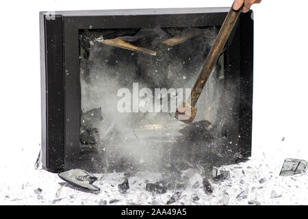 Hammer blow to television, shards flying away, white background. Breaking TV screen. Stock Photo