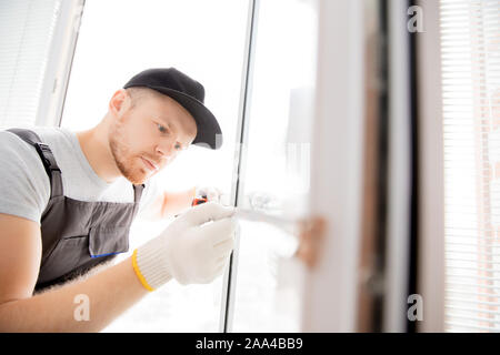 Master worker measures upvc window with ruler, installation process. Stock Photo