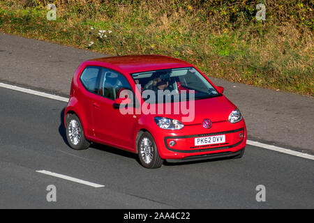 2012 red Volkswagen High UP; UK Vehicular traffic, transport, modern vehicles, saloon cars, south-bound motoring on the 3 lane M61 motorway highway. Stock Photo