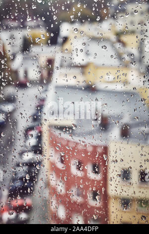 Raindrops on a window glass, color toning applied, selective focus. Stock Photo