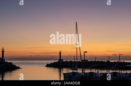 Sunrise over Cala Bona Majorca Marina full of vibrant colours and the promise of a beautiful day. Stock Photo