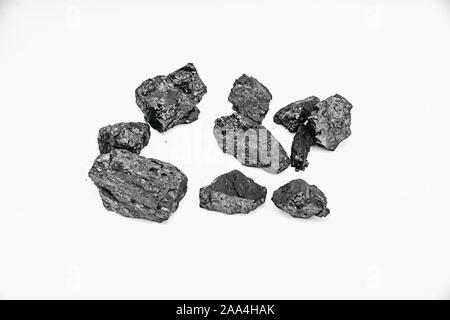 Pieces black coal lie on white isolated background, copy space. Stock Photo