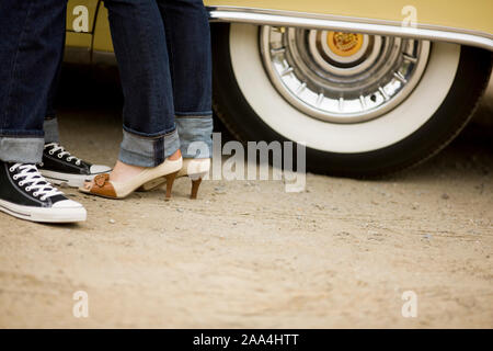 Man and woman standing next to car Stock Photo
