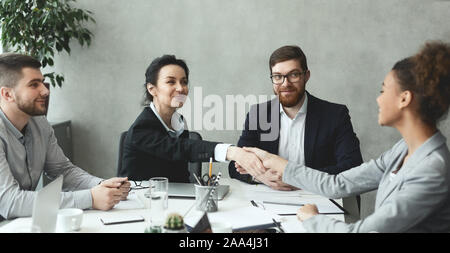 Business women shaking hands closing deal after meeting Stock Photo