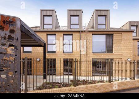 Detailed front view with bike shed and brick facade. Anglia House, Cambridge, United Kingdom. Architect: O'Connell East Architects, 2019. Stock Photo