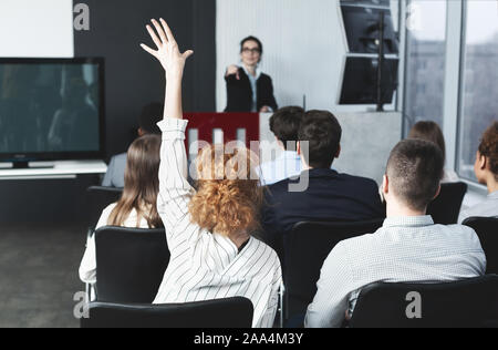I have question. Businesswoman raising hand at seminar Stock Photo