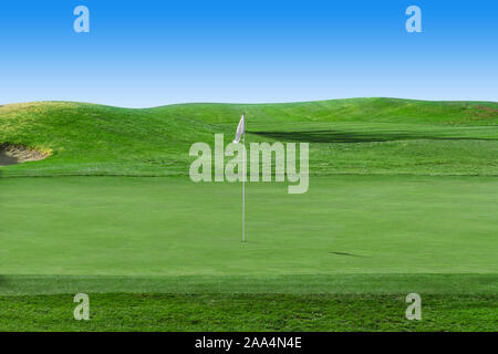 White flag on a golf course with blue sky Stock Photo