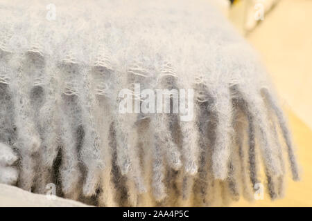 Grey wool scarf close - up with visible yarn texture and weave. Stock Photo
