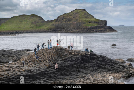 People visiting the Giants Causeway in County Antrim, Northern Ireland, UK. Stock Photo