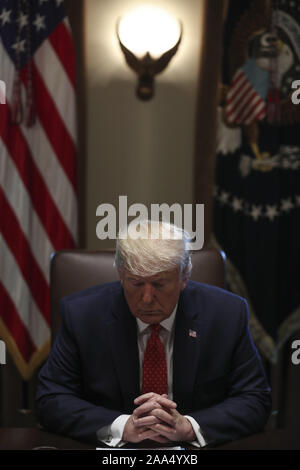 Washington, District of Columbia, USA. 19th Nov, 2019. United States President Donald J. Trump prays during a Cabinet Meeting in the Cabinet Room of the White House on November 19, 2019 in Washington, DC Credit: Oliver Contreras/CNP/ZUMA Wire/Alamy Live News Stock Photo