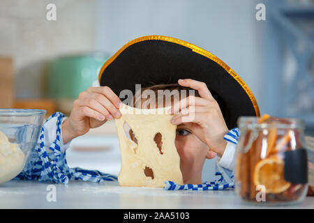 Photo session - friendly family. The family cooks together. Son kneads dough with flour. Stock Photo