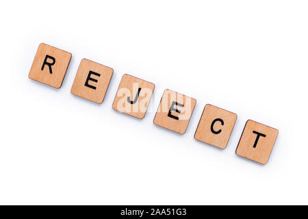 The word REJECT, spelt with wooden letter tiles over a white background. Stock Photo