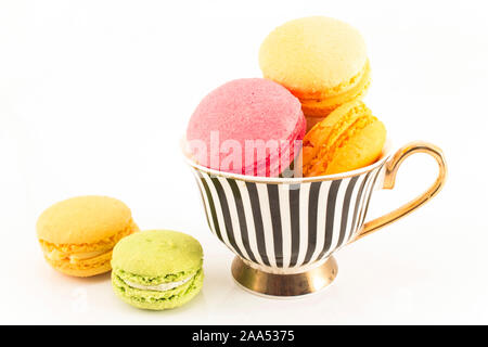 Colorful Macaroons in a Cup Isolated on White Background. Stock Photo