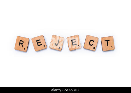 London, UK - June 13th 2019: The word REJECT, spelt with wooden letter tiles over a white background. Stock Photo