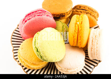 A Pile of Colorful Macaroons on a Plate on White Background. Stock Photo