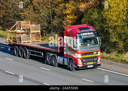 Walker Convoi Exceptional Volvo truck; Motorway heavy loads, bulk Haulage delivery trucks, lorry, transportation, delivery, transport, industry, oversize freight on the M6 at Lancaster, UK Stock Photo