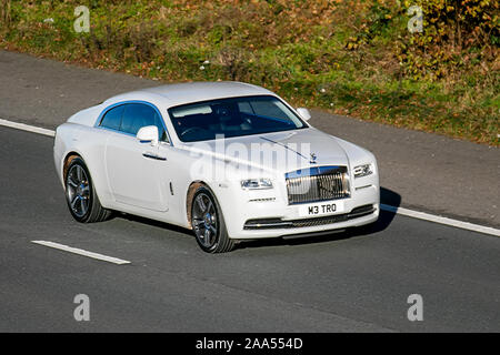 2015 white Rolls Royce Wraith V12 Auto with private number plate, personalised, cherished, dateless, DVLA registration marks, registrations; UK Vehicular traffic, transport, modern vehicles, saloon cars, south-bound motoring on the 3 lane M61 motorway highway. Stock Photo