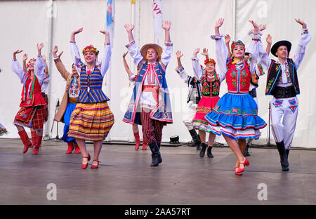 Group of Ukrainian Folklore dancers in traditional outfit dancing on stage of Etnovyr Folk Festival in Lviv Stock Photo