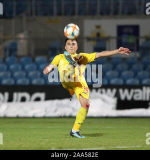 Ballymena, Antrim County, Northern Ireland. 19th November 2019; Ballymena Showgrounds, Ballymena, Antrim County, Northern Ireland; European Under 21 Championships 2021 Qualifier, Northern Ireland Under 21 versus Romania Under 21; Romania's Stefan Vladoiu clears the ball - Editorial Use Stock Photo