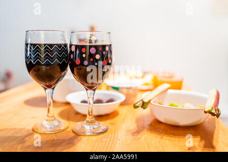 Sour foods serving setting on wooden table with rhubarb and cranberry juice or red wine two glasses for miracle berry tasting Stock Photo
