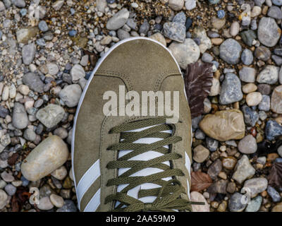 Top down view on green shoe on stone ground Stock Photo