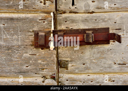 Old wooden door with rusty lock Stock Photo