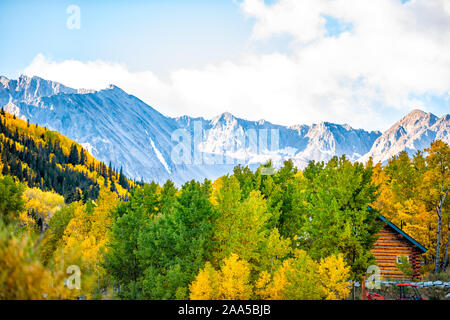 Castle Creek road wooden house cabin architecture in Ashcroft ghost town with yellow foliage aspen trees in Colorado rocky mountains autumn fall peak Stock Photo