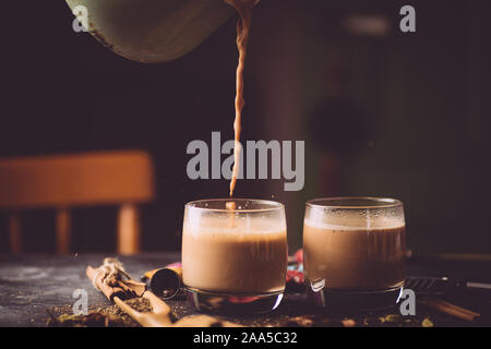 Masala tea (Masala chai). A traditional hot drink in India and South Asia. Black tea with milk and spices. Stock Photo