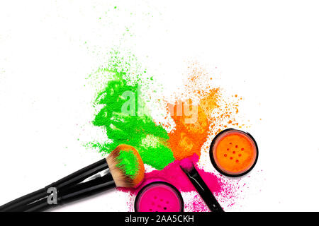 Cheek brush with neon cosmetic powder colorful pile on white background Stock Photo