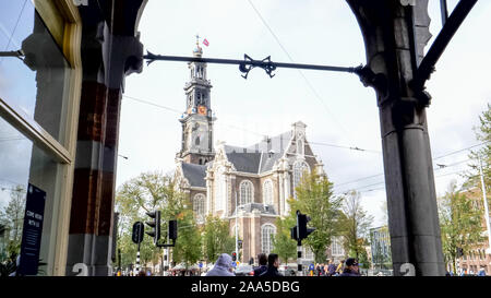 AMSTERDAM, NETHERLANDS-OCTOBER, 12, 2017: wide view of westerkerk framed by an archway in amsterdam Stock Photo