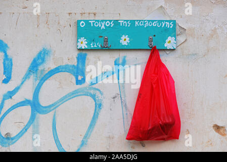 Wall of kindness. Hanger on a wall used  to hang items either food or used clothing, that can be taken by people who are in need. Stock Photo