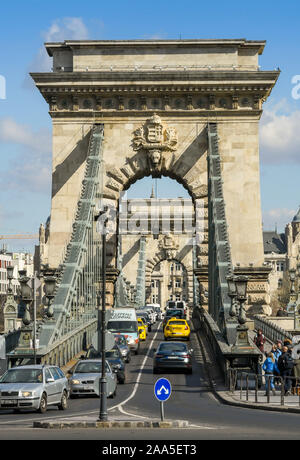 BUDAPEST, HUNGARY - MARCH 2019: Traffic crossing the Chain Bridge. It is a road bridge crossing the River Danube in the centre of Budapest. Stock Photo