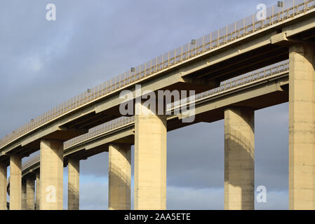 Close-up of a large concrete highway bridge in front of dark clouds in Italy Stock Photo