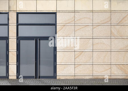 Front view of a building wall with closed door. Stock Photo
