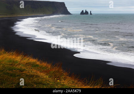 Famous Reynisdragar rock formations at black Reynisfjara beach coast of the Atlantic Ocean near village of Vik, Southern, Iceland Stock Photo