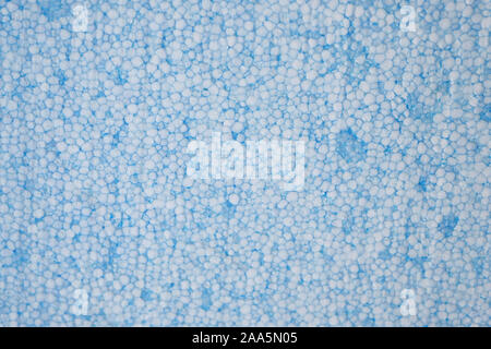 foam plastic closeup top view. A blue piece of polystyrene for insulation of houses. Stock Photo