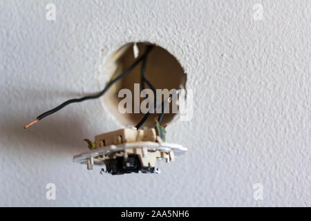 Light switch disassembled with exposed wires Stock Photo